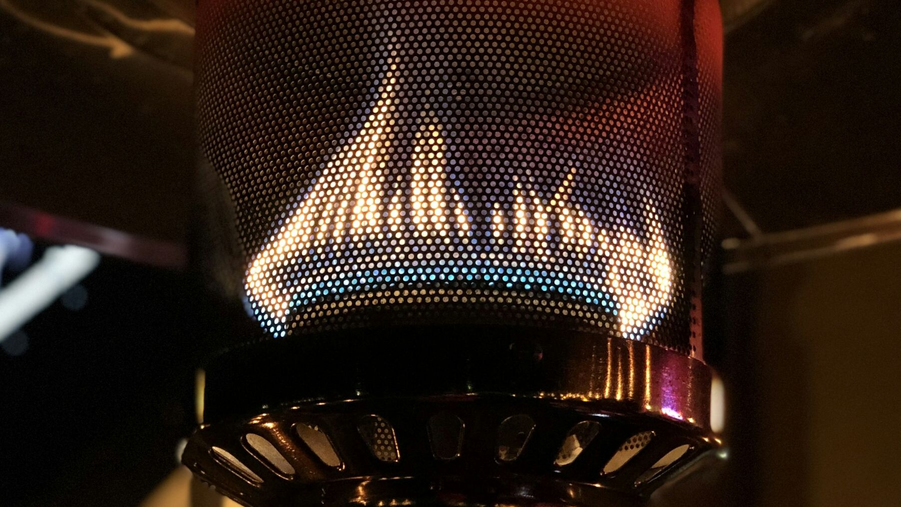 A blue and orange gas flame burning inside a heater