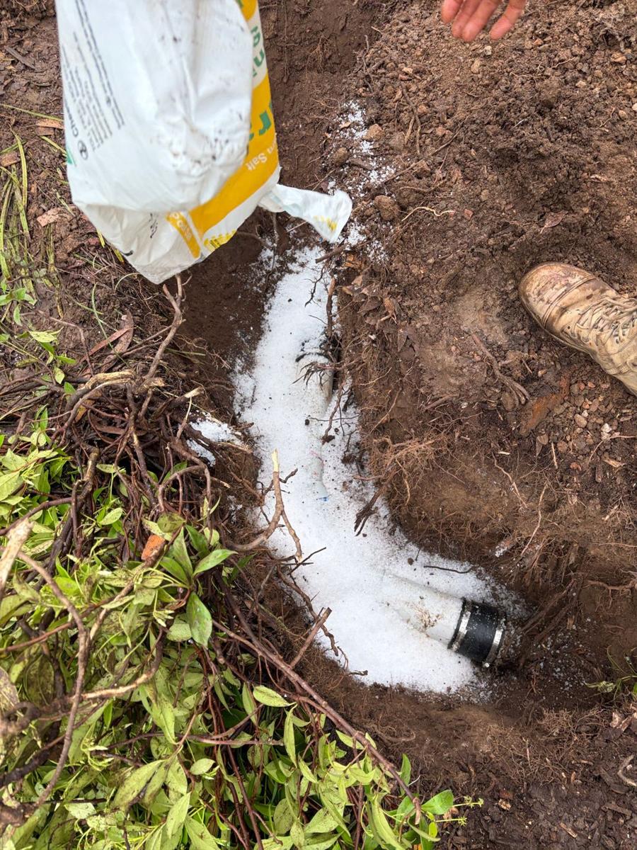 Concrete mix being placed over the new drain pipe to protect the repair